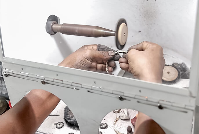 Jewellery artisan working on diamond and gold bracelet at our factory